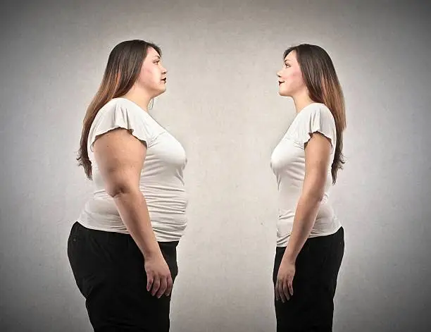 fat woman and woman lean in comparison on gray background