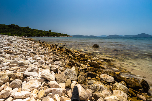 A desolated pebble beach on the Adriatic Sea near the city of Dubrovnik. The water is crystal clear with a turquoise color. During summer the most beaches in the Dalmatian Area and Adriatic Coast are overpopulated except when you look good, you can find these hidden gems.