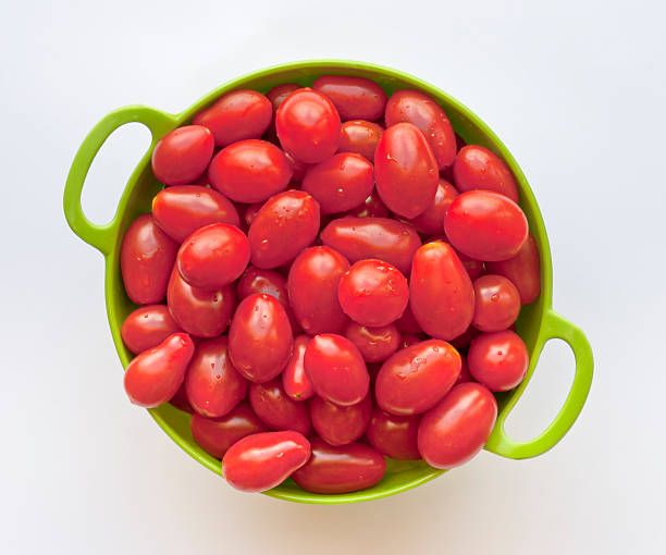 Grape tomatoes Sweet red grape tomatoes. White background, overhead shot.   More like this - grape tomato stock pictures, royalty-free photos & images