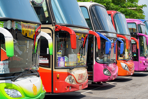 Kaohsiung, Taiwan - April 29, 2019: Colorful view of tourist buses at parking area. Taiwan is a popular tourist destination of Asia.