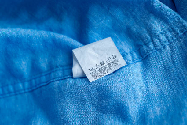 istock Clothing label on light blue garment, top view 1609438872