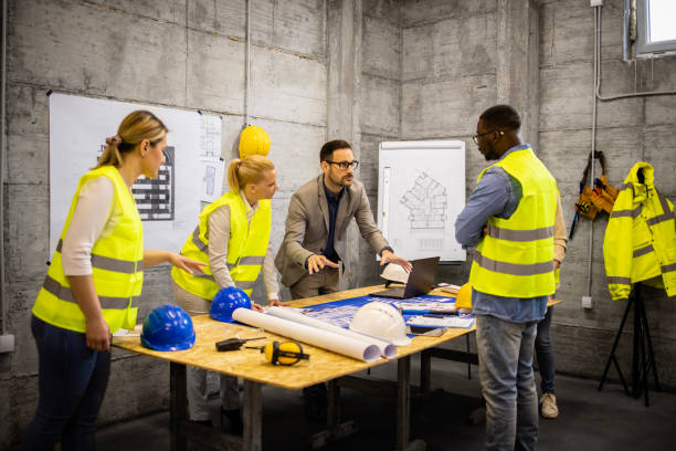 istock Team of experts in construction business having a site meeting discussing about the project. 1609439769