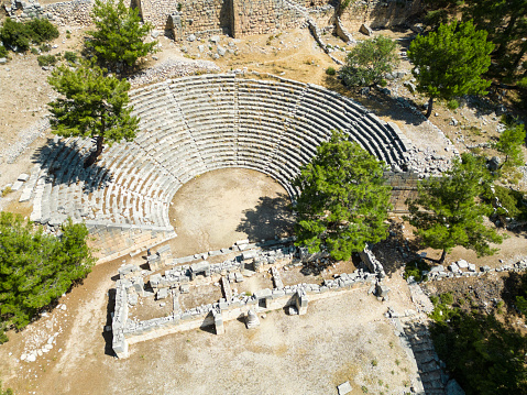 Ruins of the Bouleuterion council house at ancient Greek city Teos in Izmir province of Turkey. Teos was an ancient Greek city on the coast of Ionia. Teos was a flourishing seaport with two fine harbours until Cyrus the Great invaded Lydia and Ionia (c. 540 BC). The Bouleuterion was partially revealed in 1924.