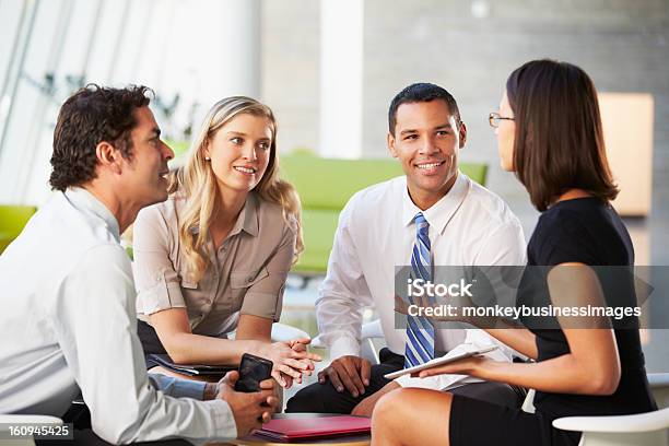 Businesspeople With Digital Tablet Having Meeting In Office Stock Photo - Download Image Now