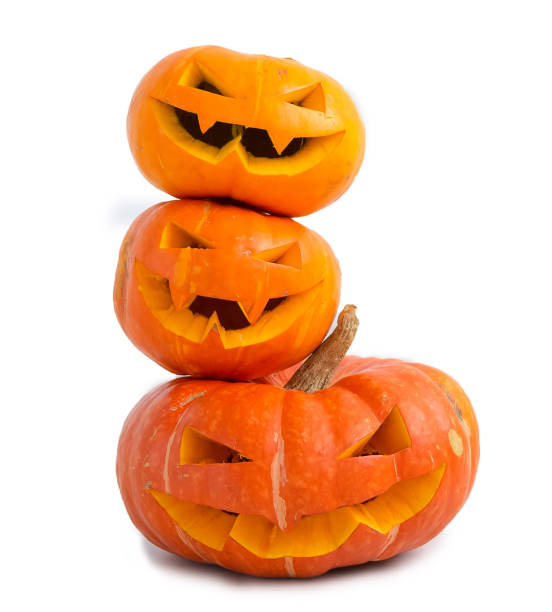 istock Jack-o-lantern carved pumpkin on light wall background with copy space, autumn and halloween home decor 1609458166