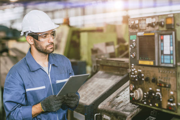 istock Hispanic latin indian male worker working control operate lathe CNC machine in heavy metal  steel factory 1609465018