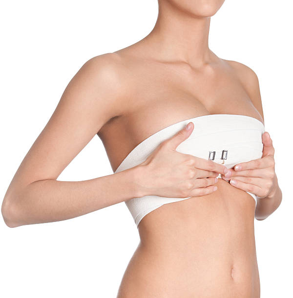 Woman ready for breast correction surgery Breast correction, isolated, white background breast photos stock pictures, royalty-free photos & images