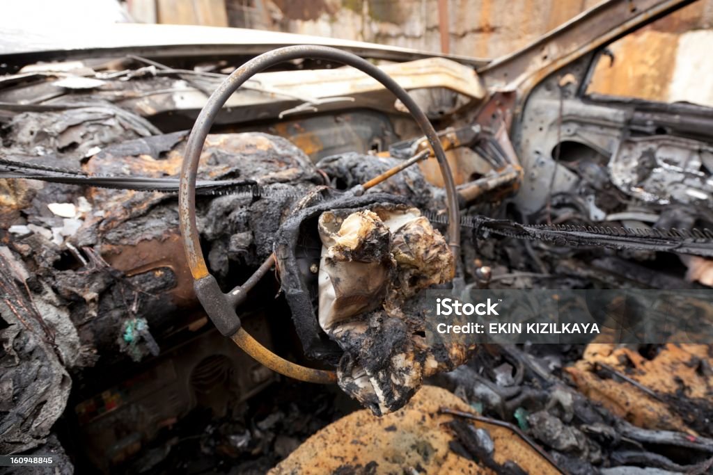 Car crash, burnt-out wreck A wrecked car on the roadside, burnt-out. close-up Arson Stock Photo