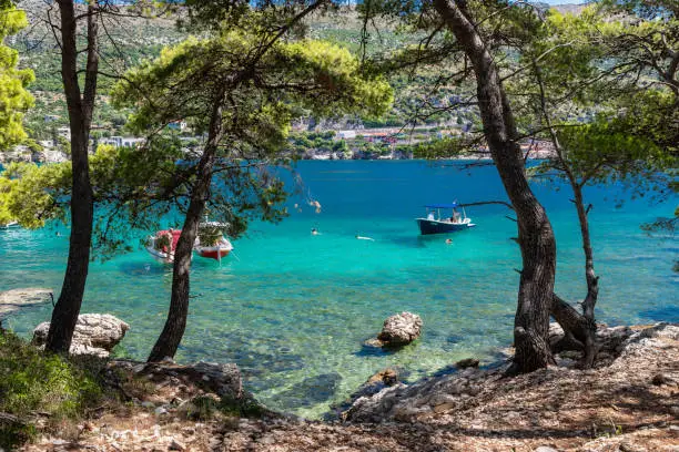 A beautiful bay at the Dalmatian Coastal line close to Dubrovnik with crystal clear and turquoise waters, creating a feeling of paradise