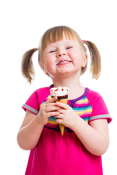 istock happy kid girl eating ice cream in studio isolated 160951494