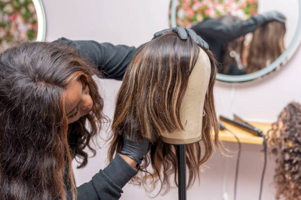 istock a young hairdressing student working the wig on mannequin's head 1609541819