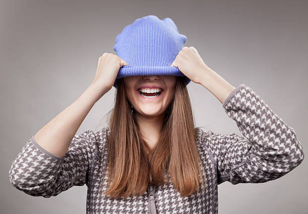 istock The cheerful girl laughs, having pulled a cap over eyes 160956383