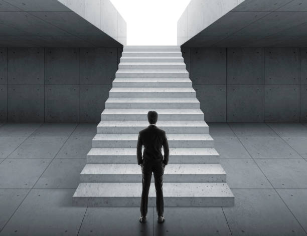 istock Businessman looking at stairs. business start concept 1609564653