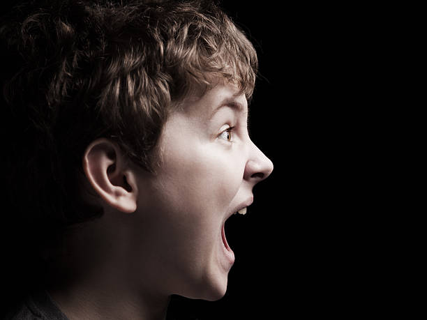Closeup portrait of a boy  screaming stock photo