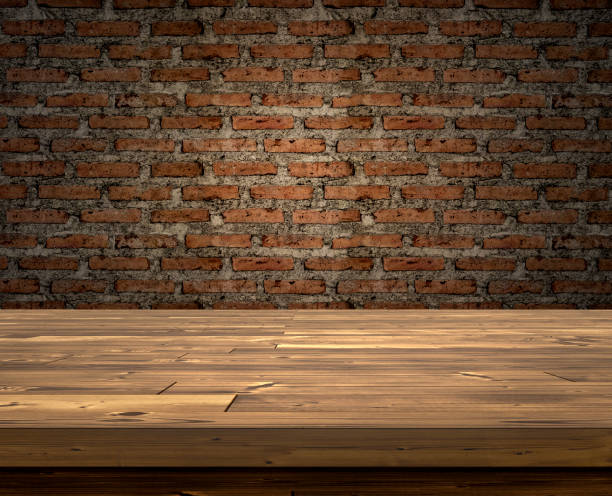 istock Wooden table in dark brick wall room for advertising 1609565175