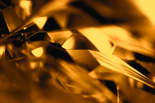 istock Macro close-up image of cut crystal pattern engraved in gold amber color image. 1609582104