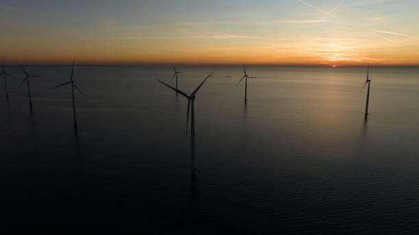 istock Drone shot of wind turbines on sea 1609591625