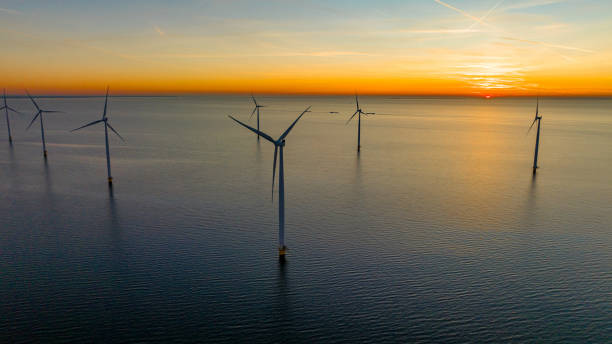 istock Drone shot of wind turbines on sea 1609591639