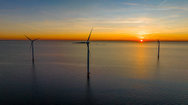 istock Drone shot of wind turbines on sea 1609591644