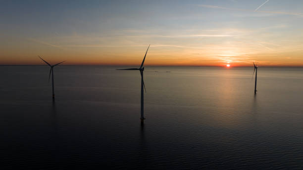 istock Drone shot of wind turbines on sea 1609591652