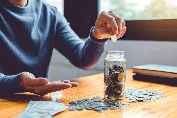 istock Saving money concept Man hand putting Row and coin stack growing business 1609592758