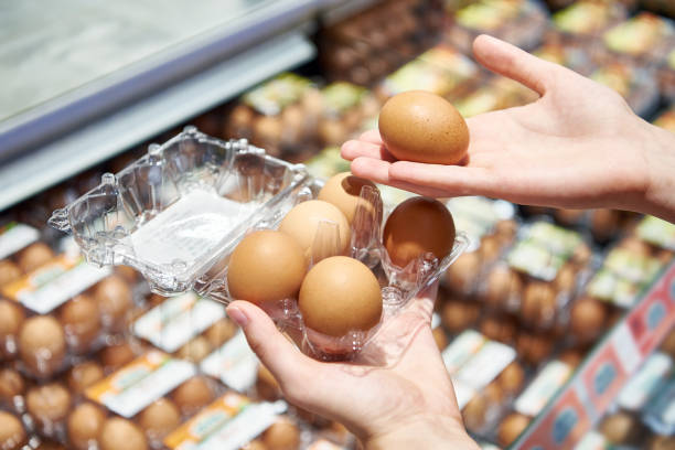 istock Woman with packing eggs in shop 1609596328