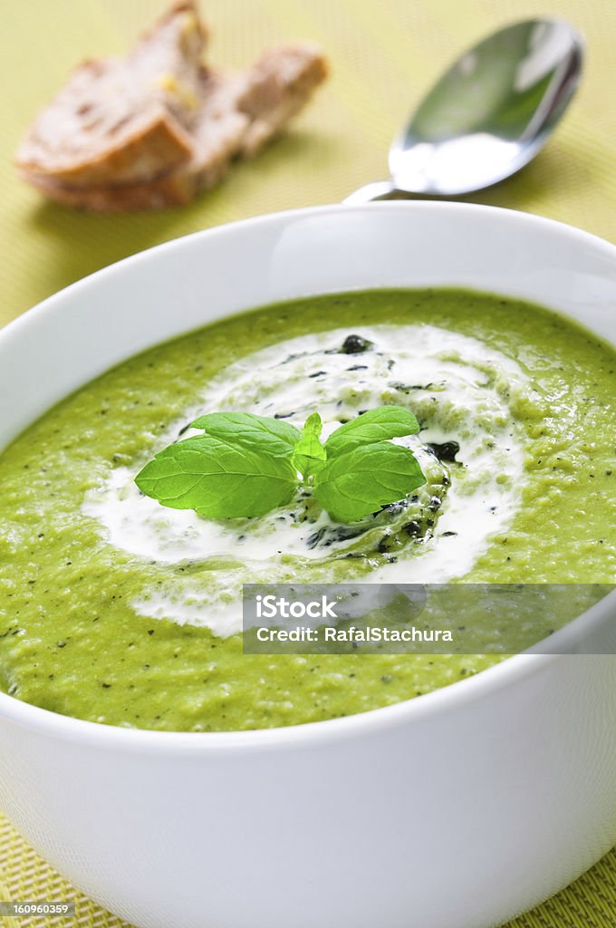 Vegetable soup Fresh vegetable soup topped with cream and mint Appetizer Stock Photo