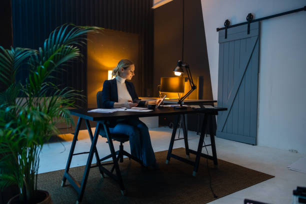 istock Female entrepreneur working till late on digital tablet at office 1609603622