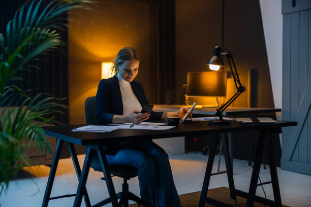 istock Female entrepreneur working till late on digital tablet at office 1609603668