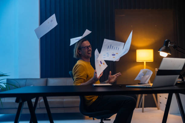 istock Businessman throwing paper and celebrating success in office 1609603743