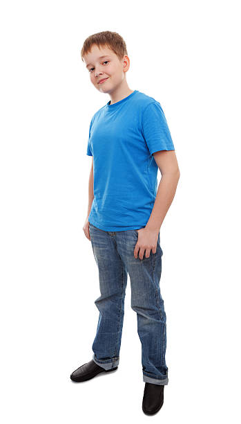 Young preteen boy standing and smiling at camera stock photo