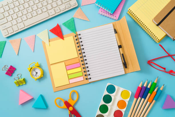 istock Back to school concept with notebook, school supplies and computer keyboard on blue background. Top view, flat lay 1609617546