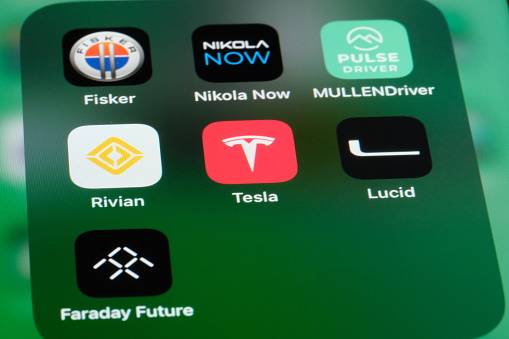 Shanghai,China-August 9th 2023: Tesla, Rivian, Lucid, Fisker, Nikola, Mullen and Faraday Future app icons. Assorted American EV company brands