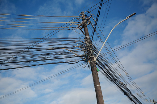 salvador, bahia, brazil - august, 25, 2022: Electric network wiring and TV network cables on a pole of the electric network in the city of Salvador.