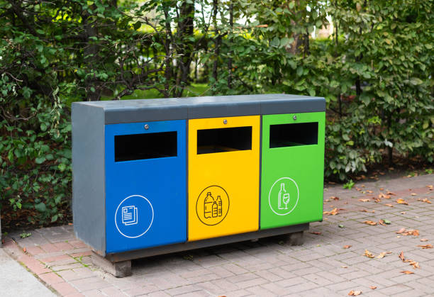 istock Three different garbage container for sorting waste in the park. Yellow for plastic, green for glass, blue for paper. Separating and sorting trash, concept pollution of the environment. 1609692158