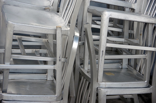 Large stack of aluminium outdoor chairs