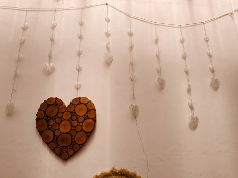 A wooden ornament in the shape of a heart or love