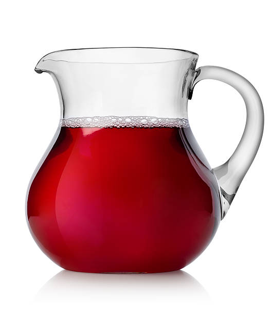Pomegranate juice in a jug isolated on white background