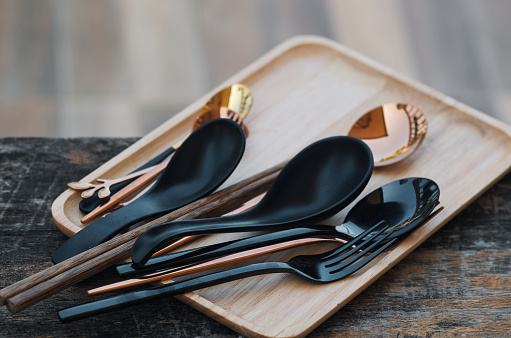 forks and spoons on the wooden tray
