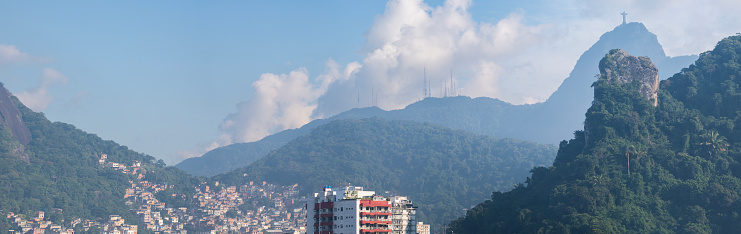 Brazil: skyline of Rio de Janeiro with the Rocinha favela, green vegetation and view of the Mount Corcovado and Christ the Redeemer, one of the seven  wonders of the modern world