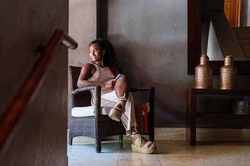 Beautiful Afro woman from Cartagena Colombia between 20 and 29 years old, arrives at her hotel enjoying the tropical climate and the beautiful architecture of the place