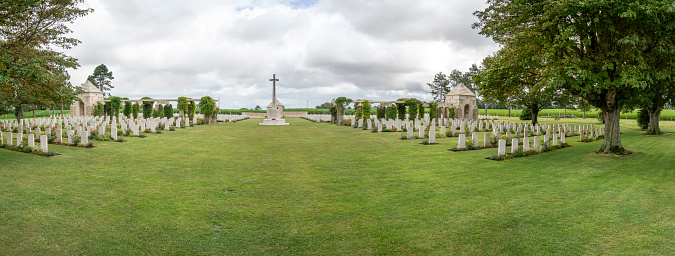 Ryes, France - 07 24 2023: Bazenville British Military Cemetery. View of Memorial and the white tombstones of soldiers