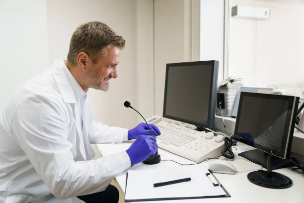 istock Doctor radiologist controls MRI or CT or PET Scan with patient undergoing procedure 1609844311