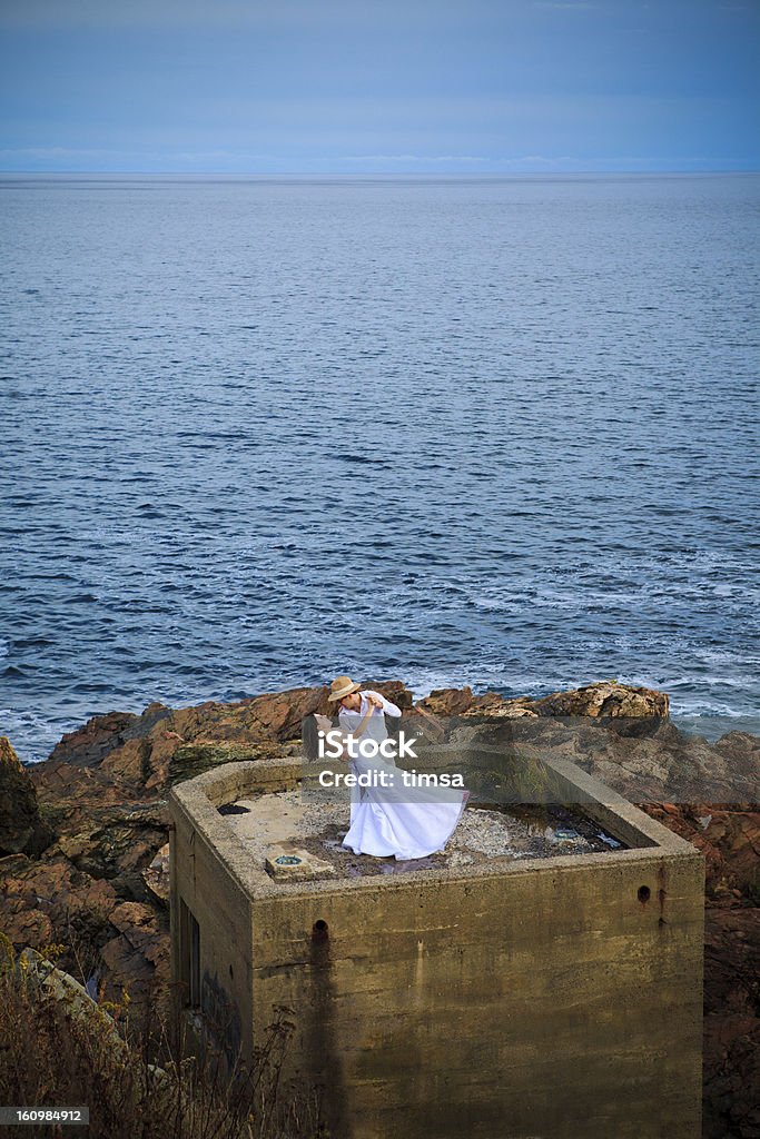 Wedding dance at blue hour on concrete bunker Adorable young couple dancing the waltz as dusk falls on top of a concrete observation post on the Atlantic ocean. Copyspace.  Bomb Shelter Stock Photo
