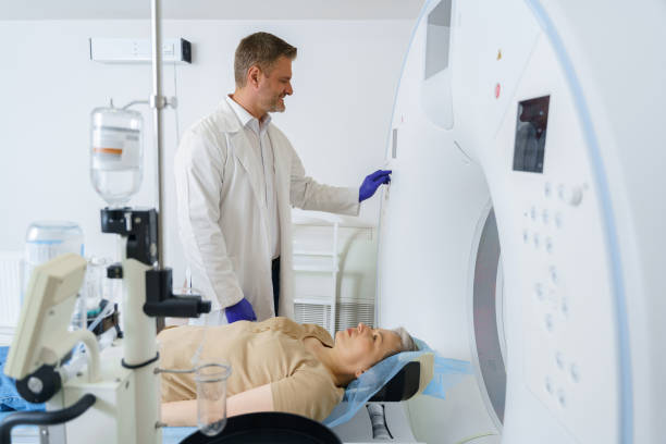 istock Doctor radiologist pushing button on panel to start mri scan procedure for female patient 1609849379