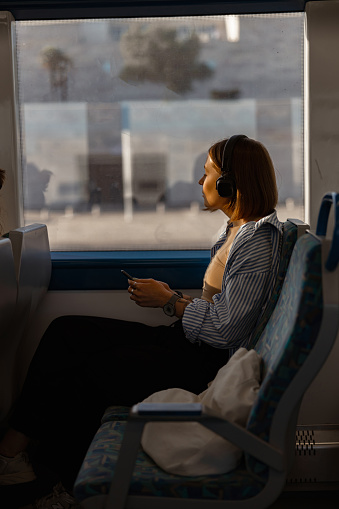 Woman tourist traveling in public transport and looking view outside the window. High quality photo