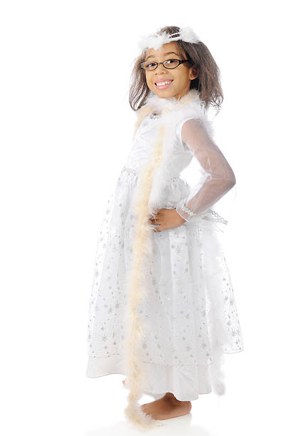 A pretty elementary girl happily showing off her white dress and boas.  On a white background.