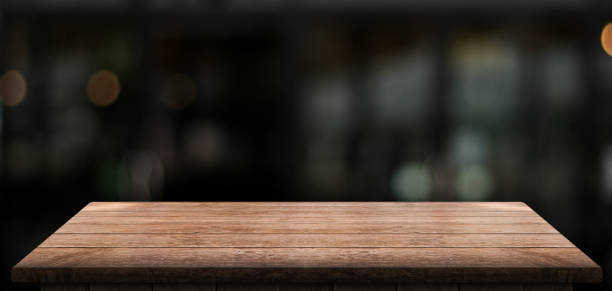 istock Empty wooden table top with lights bokeh on blur restaurant background. 1609871358
