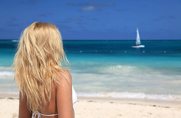 Young woman in bikini enjoying the day at  Caribbean beach stock photo