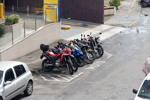 Salvador, Bahia, Brazil - August 11, 2023: Motorcycles parked on one of the streets parallel to Avenida Tancredo Neves in the city of Salvador, Bahia.